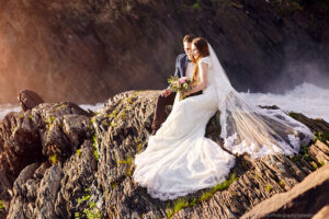 Wedding photography couple sitting on rocks